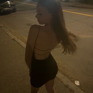 Black dress with open back and scrunched bottom.